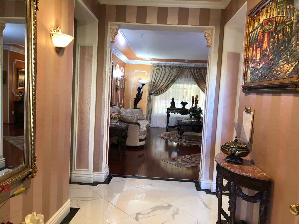 Elegant hallway leading to a sophisticated living room area.