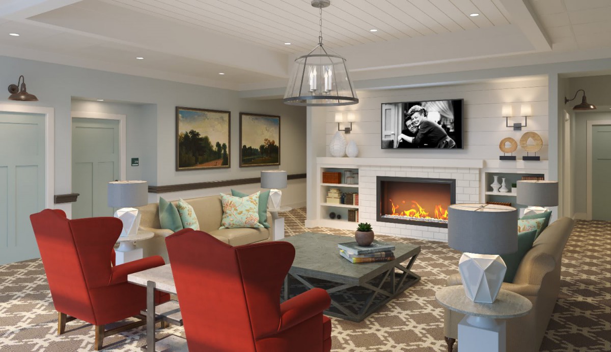 A modern living room with a cozy fireplace, stylish furniture, and artwork on display.