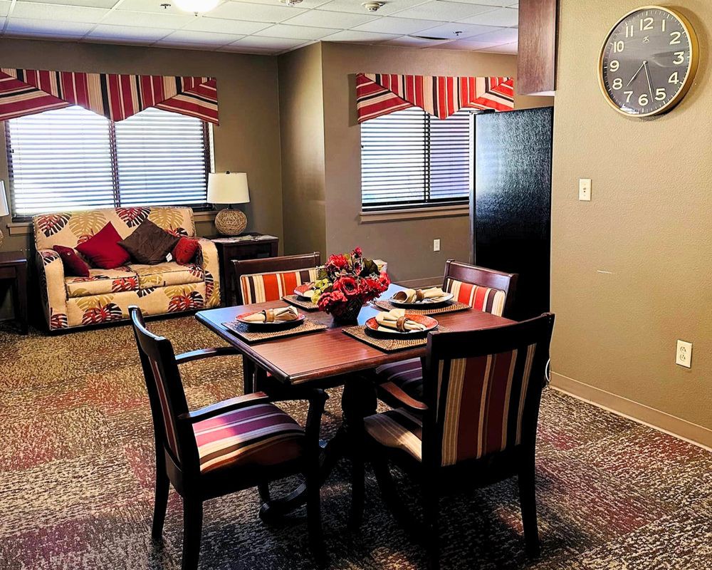 A cozy dining and living area with warm colors and stylish furniture.