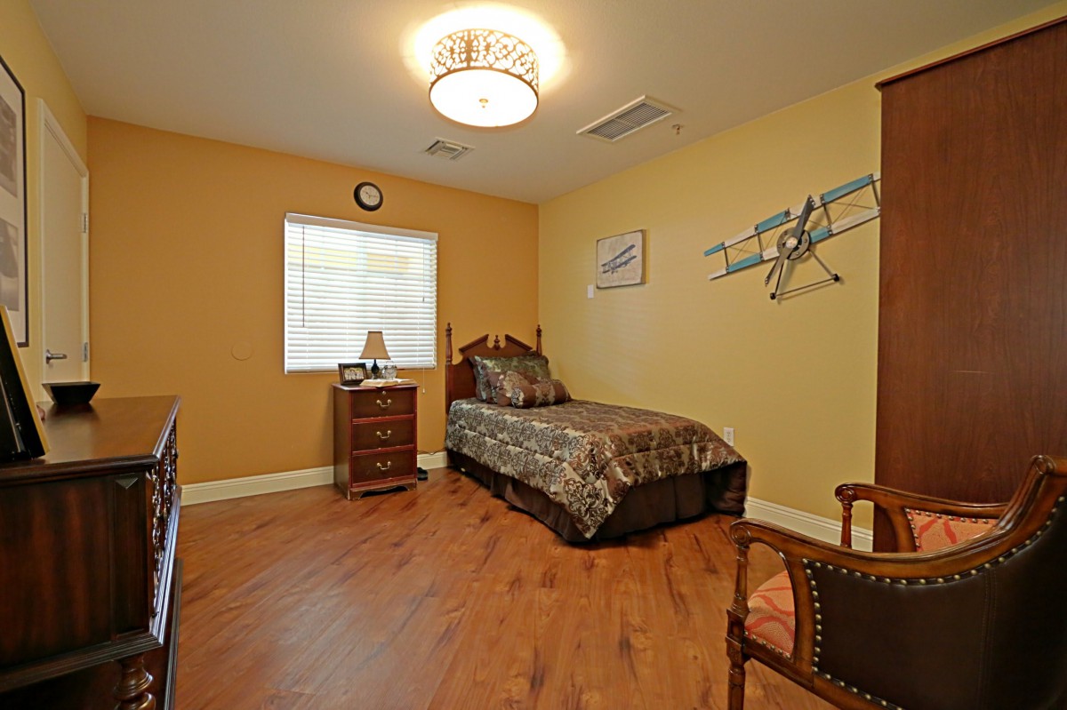 A cozy bedroom with a single bed and warm, inviting decor.
