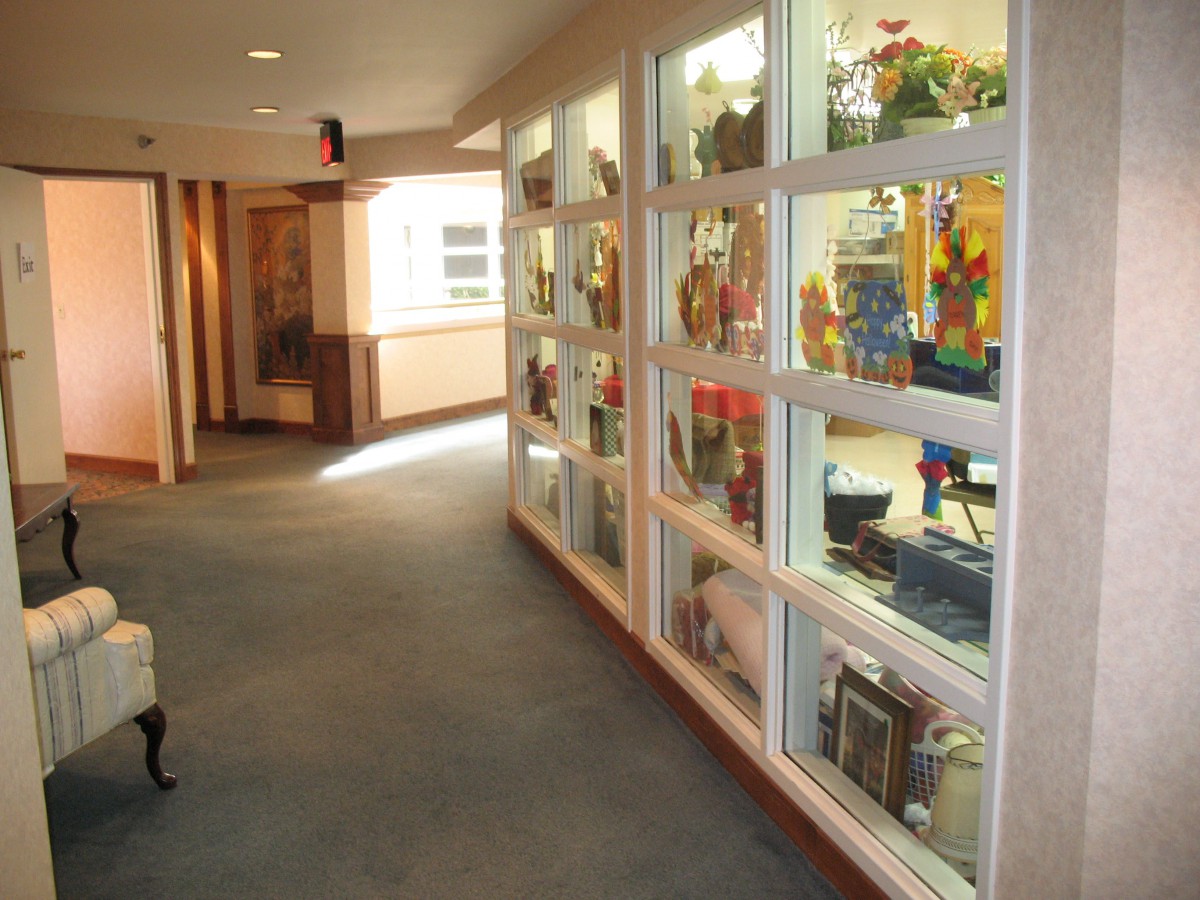 A hallway with glass display cases showcasing various artifacts.