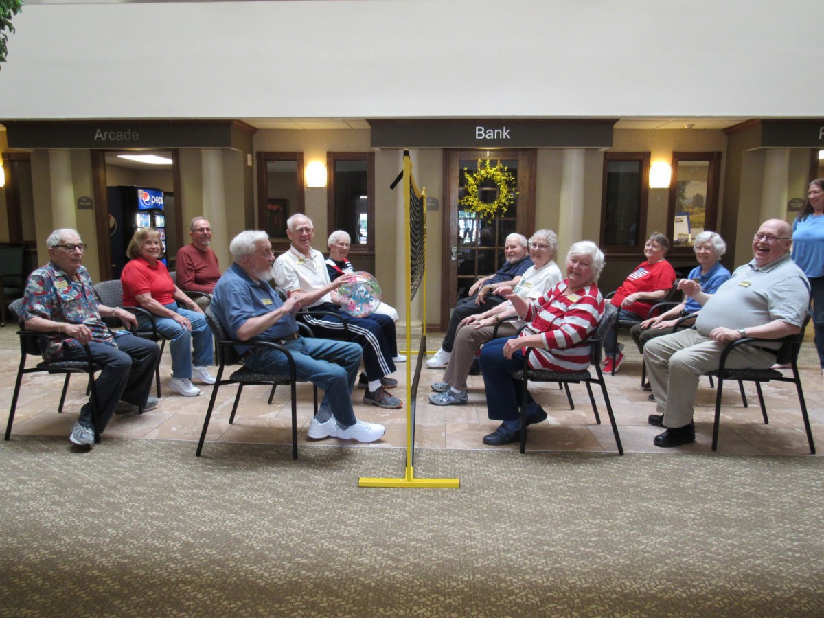 A group of seniors engaged in a communal activity indoors.
