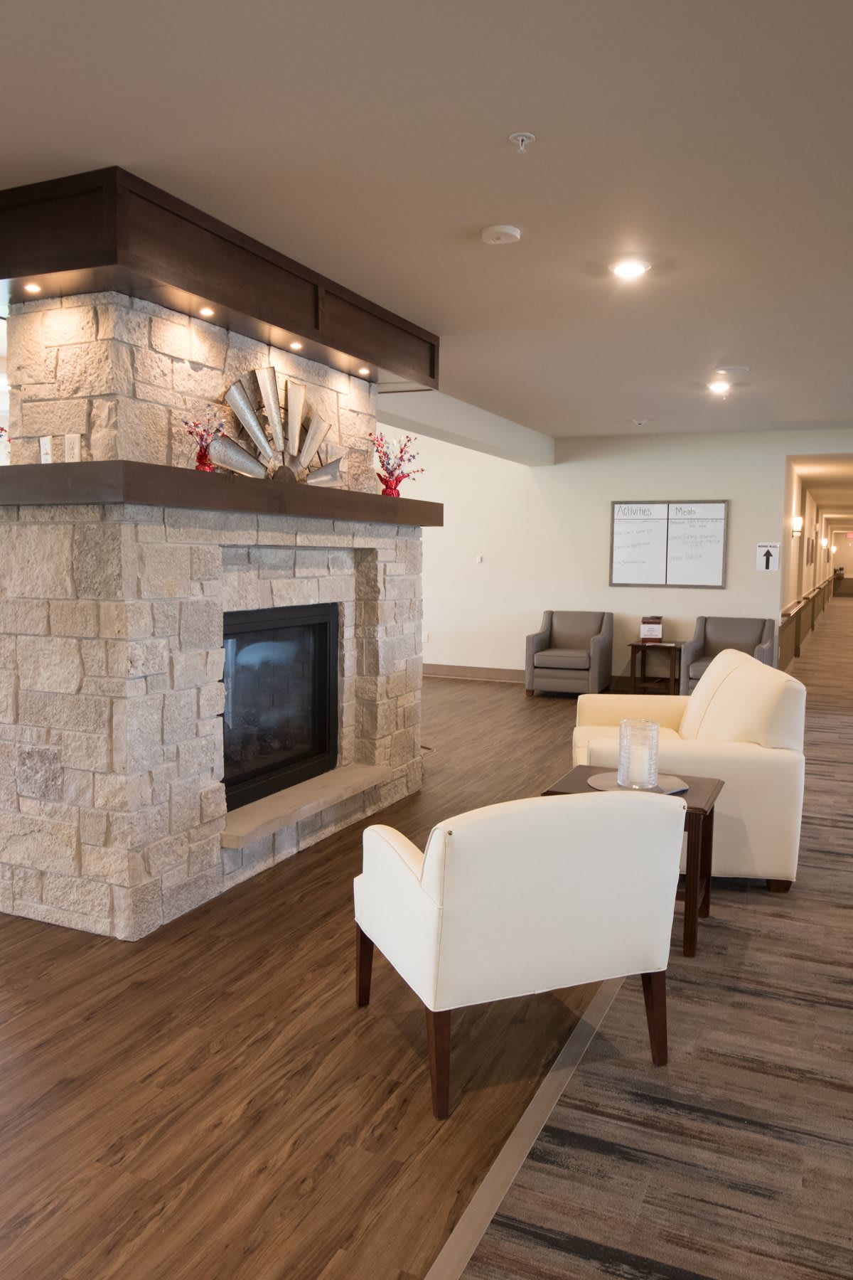 A modern lobby with a stone fireplace, comfortable seating, and elegant decor.