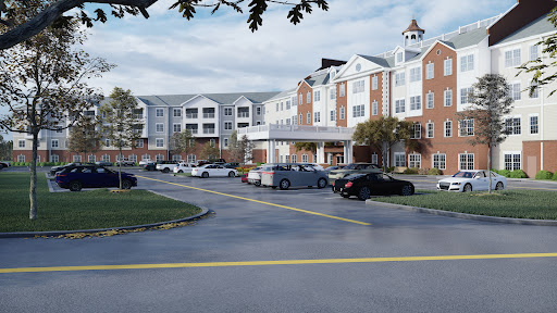 A residential building with a parking lot, set against a cloudy sky.