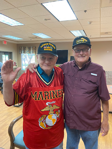 Two veterans sharing a moment together, showcasing their pride in service.
