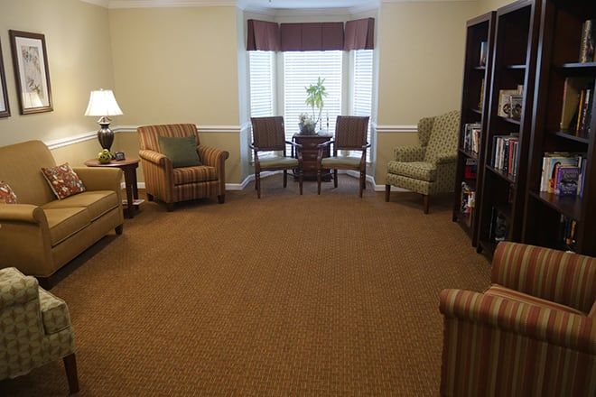 A cozy living room with comfortable seating and a window view.