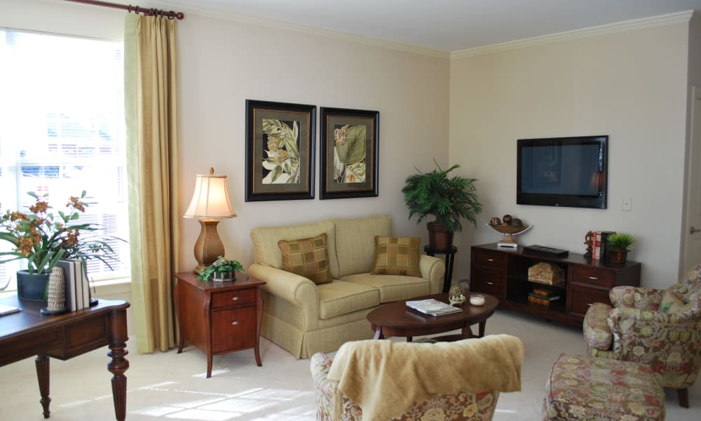 A cozy living room with a sofa, decorative pillows, and artwork on the wall.