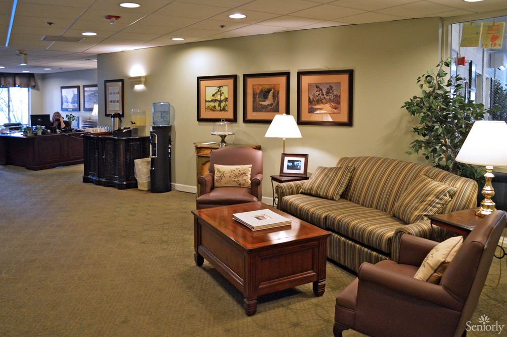 A cozy waiting room with comfortable seating and warm lighting.