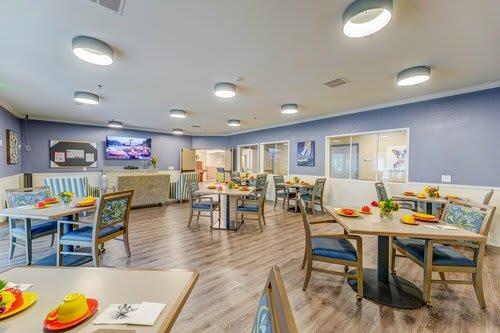 A bright and modern dining room with neatly arranged tables and chairs.