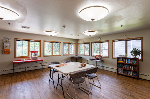 A bright and spacious meeting room with ample natural light and basic furniture.
