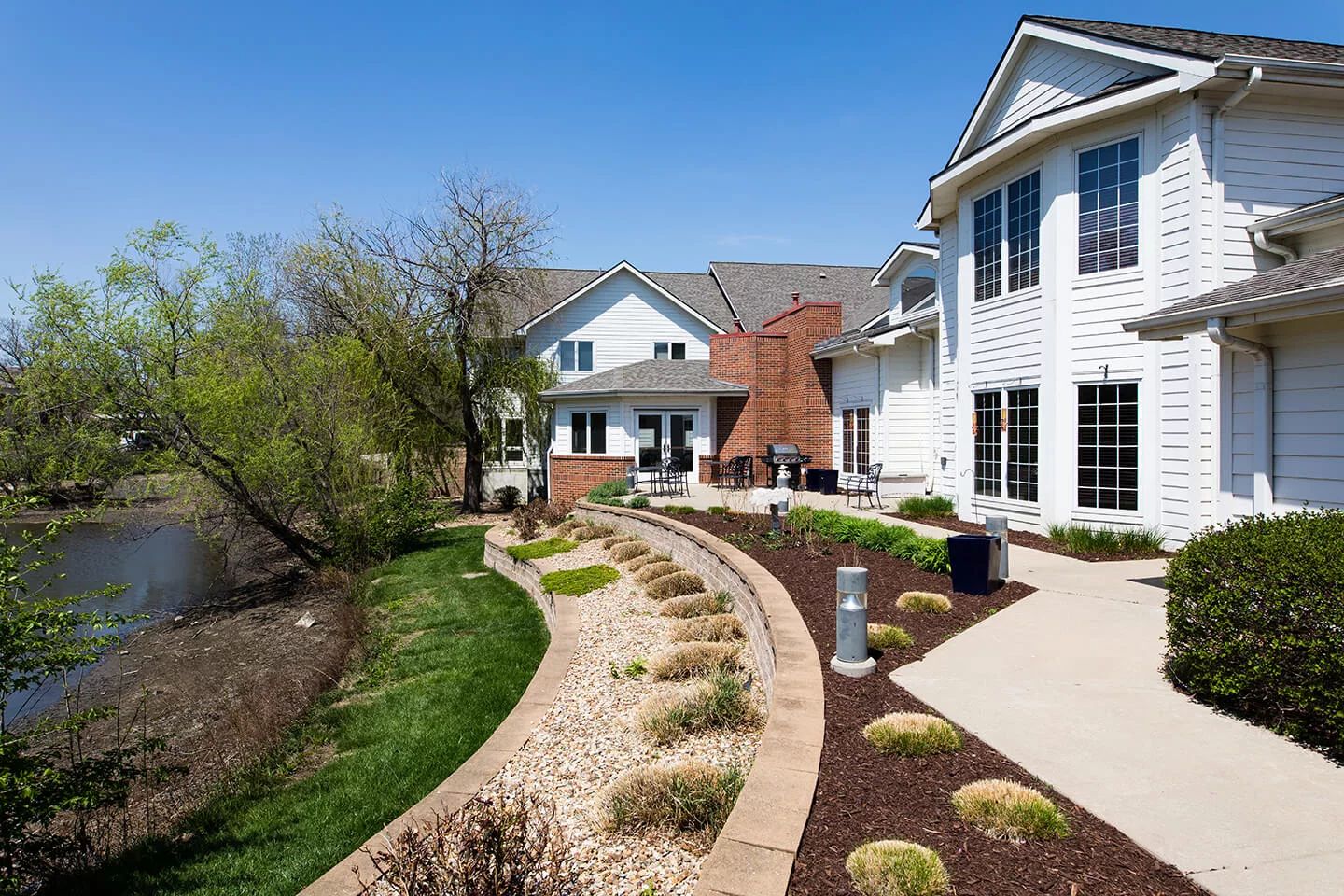 A beautiful modern house with landscaped garden and curving pathway.