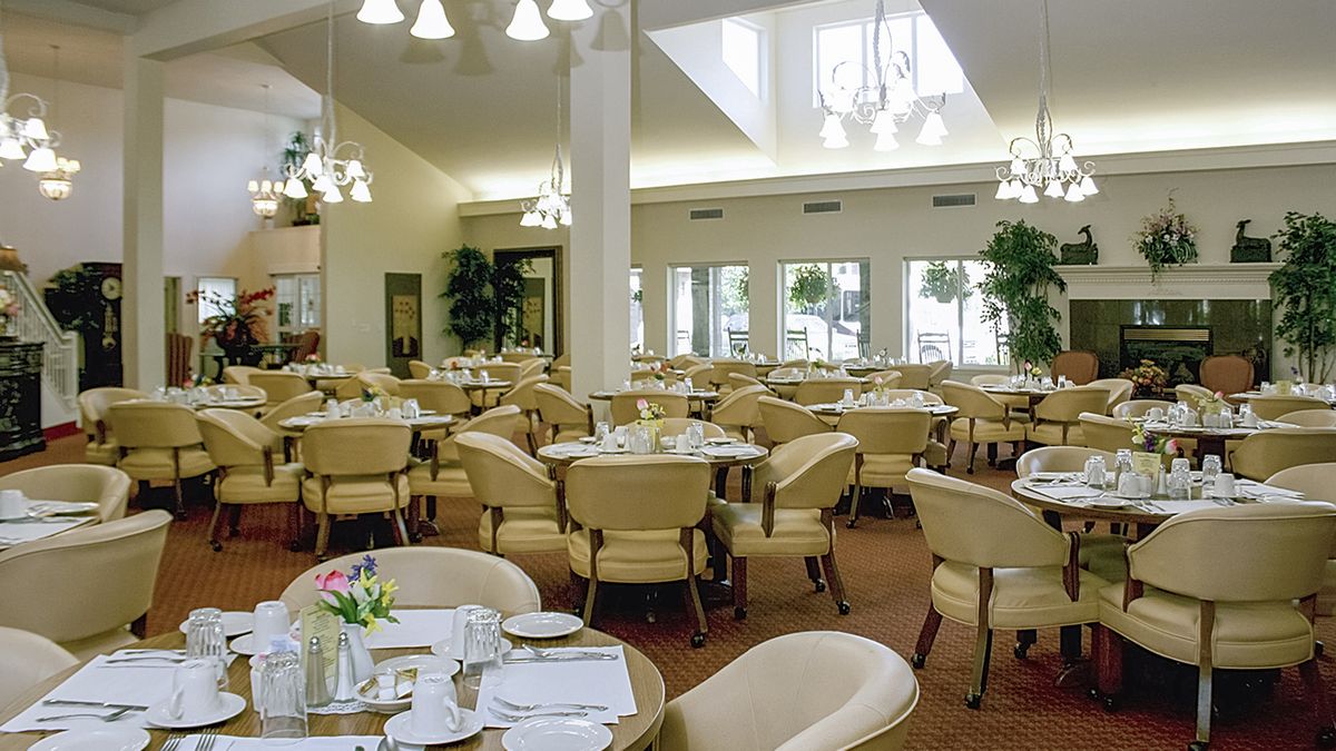 An elegant dining room with neatly arranged tables and chairs, ready for guests.