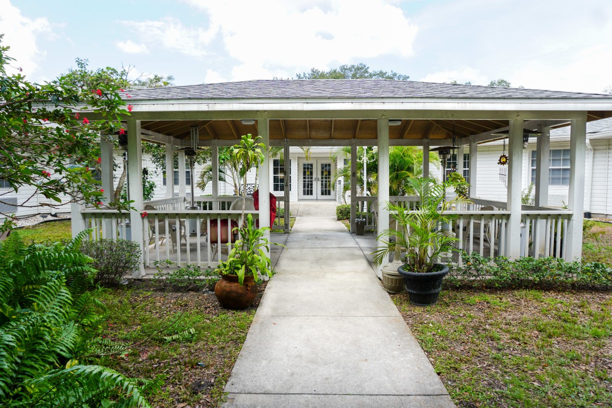 A charming house with a covered porch and garden pathway leading to the entrance.
