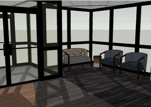 A modern sunroom featuring comfortable seating and large glass windows.