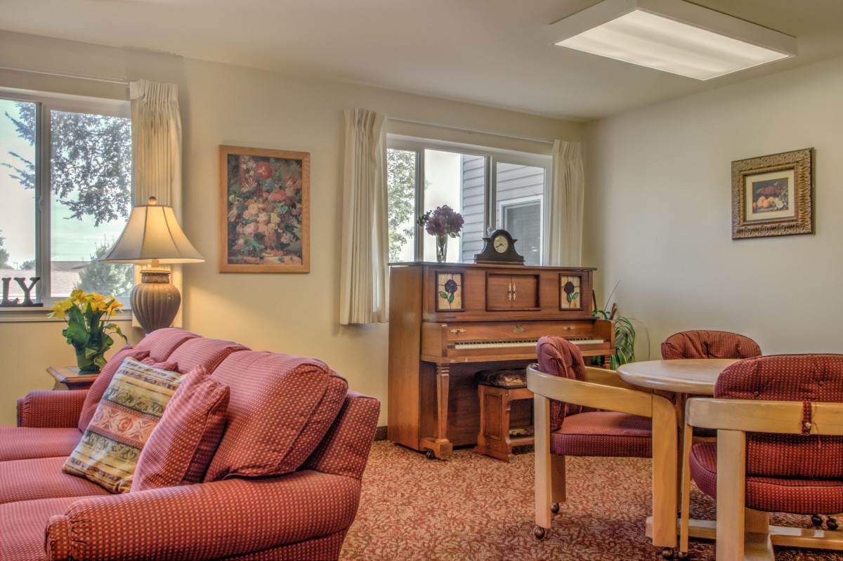 Cozy living room with a piano and comfortable seating arrangement.