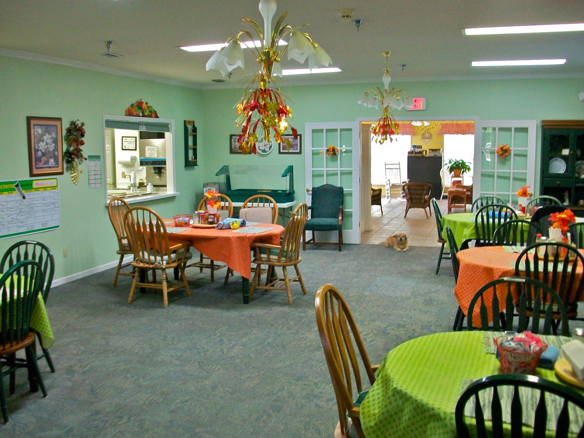 A cozy dining room with colorful table settings and decorative elements.