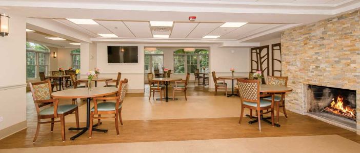 A spacious dining room with elegant furniture and large windows.