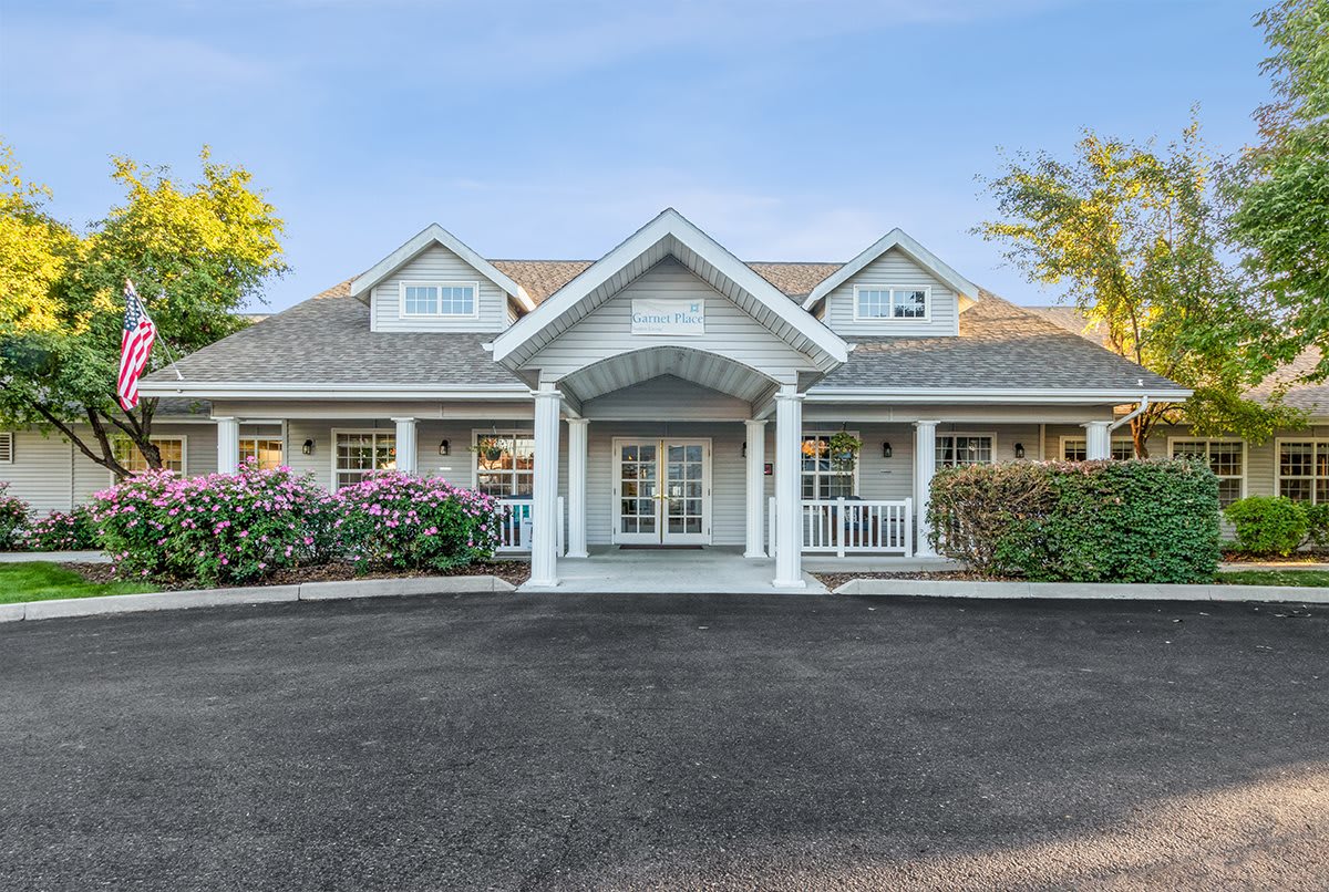 A beautiful residential house with a manicured front yard and driveway.