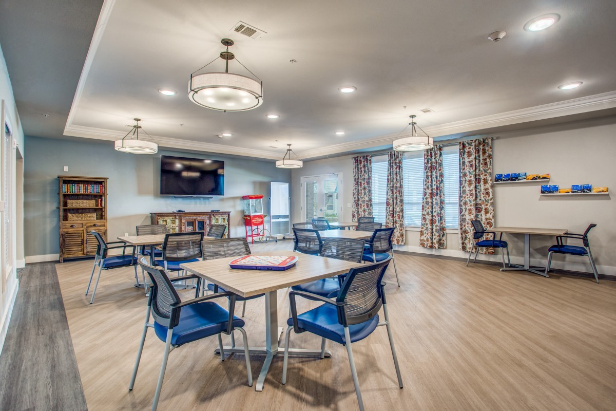A modern and spacious dining area with stylish lighting and seating arrangements.