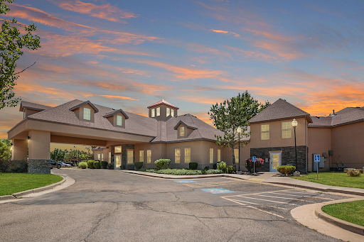 A picturesque hotel exterior captured during sunset, showcasing its welcoming architecture and landscaped surroundings.