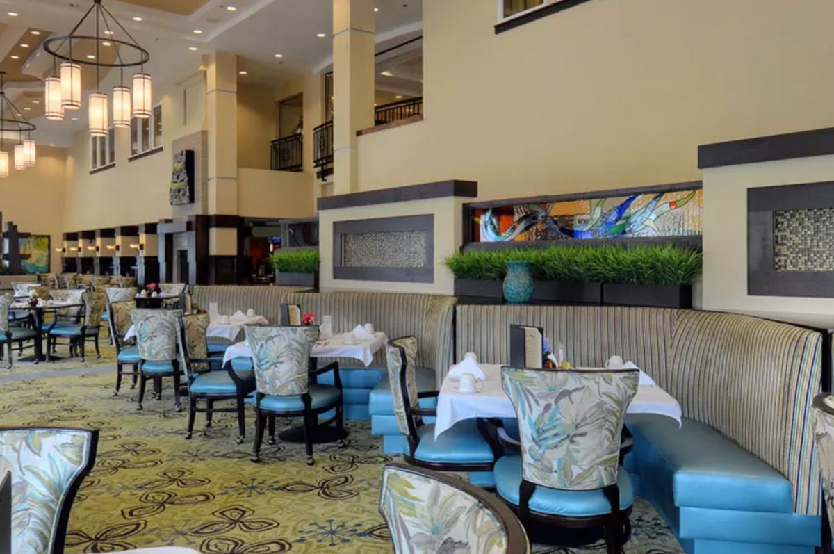 A modern restaurant interior with elegantly set tables and stylish decor.