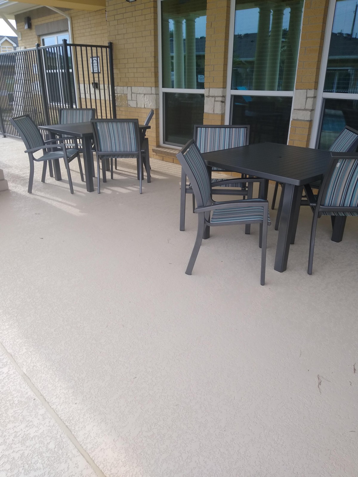 Outdoor patio area with tables and chairs.