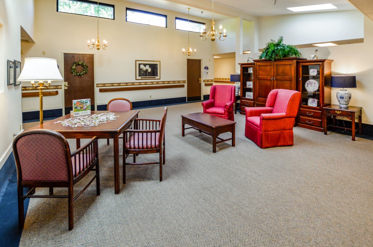 A cozy living room with comfortable seating and a wooden dining set.
