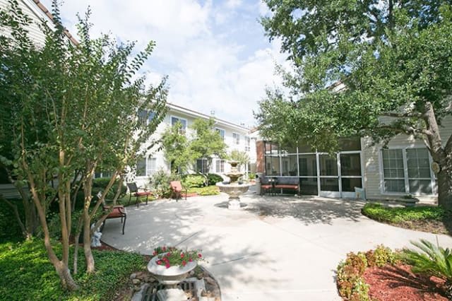 A spacious courtyard with greenery and comfortable seating, perfect for relaxation.