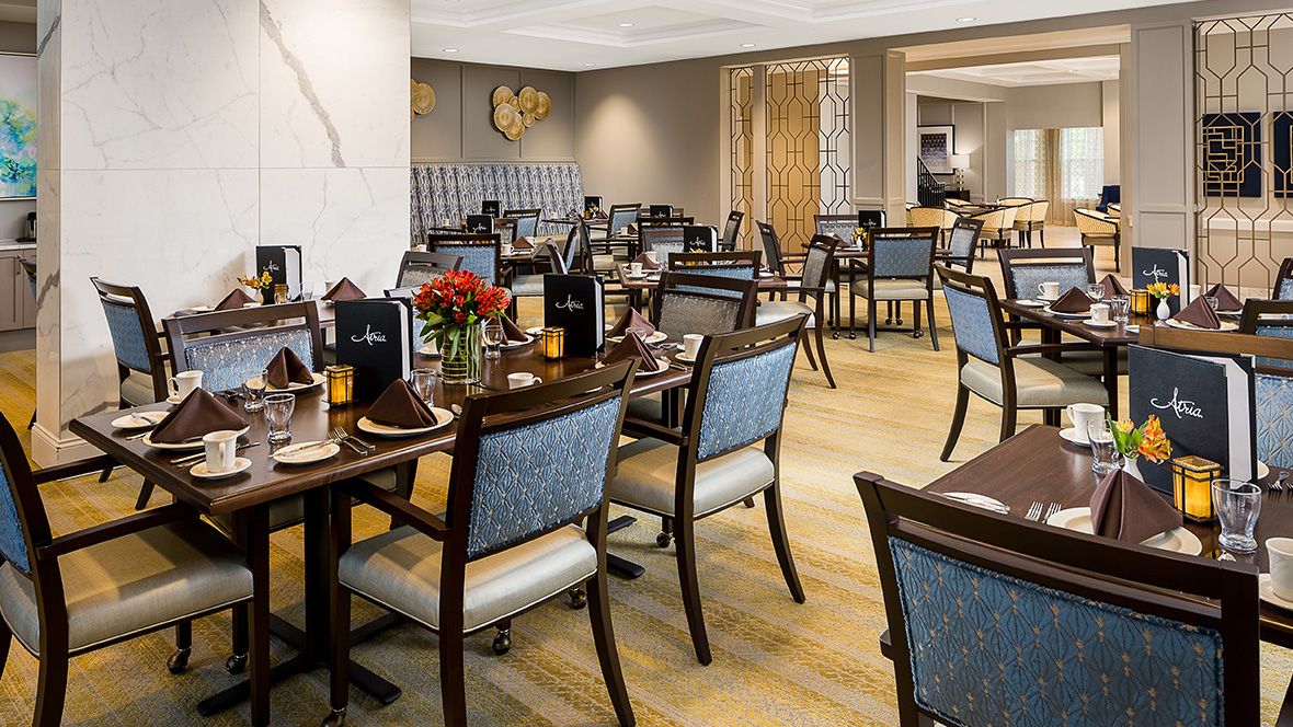 An elegant restaurant interior with neatly arranged tables and chairs, ready for guests.