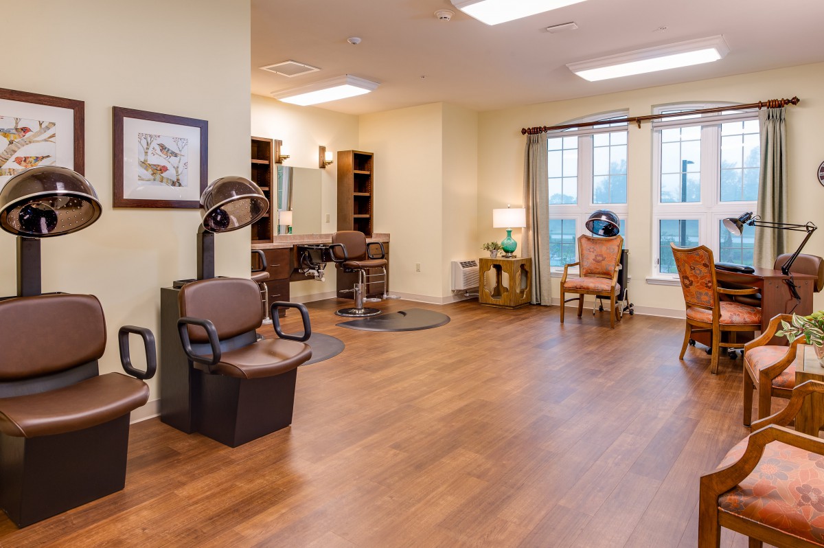 A cozy hair salon interior with chairs, mirrors, and styling stations.