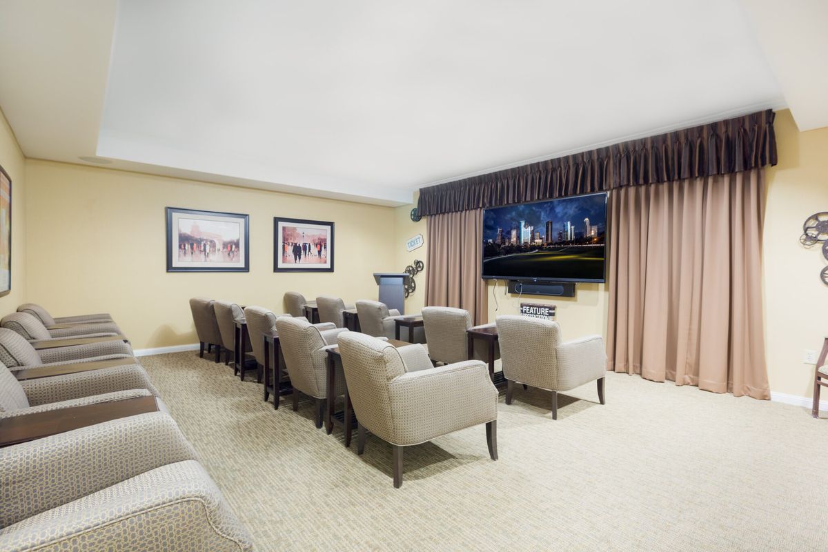 A modern home theater setup with comfortable seating and a large screen.