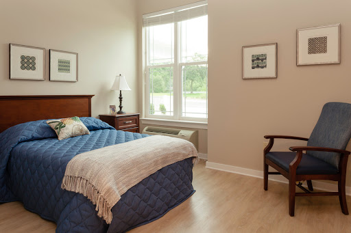 A cozy and well-lit bedroom featuring a comfortable bed, elegant furnishings, and a serene atmosphere.