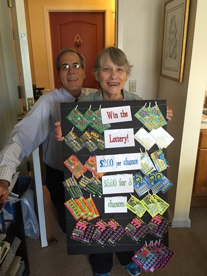 A couple celebrating retirement with a creative gift board featuring lottery tickets.
