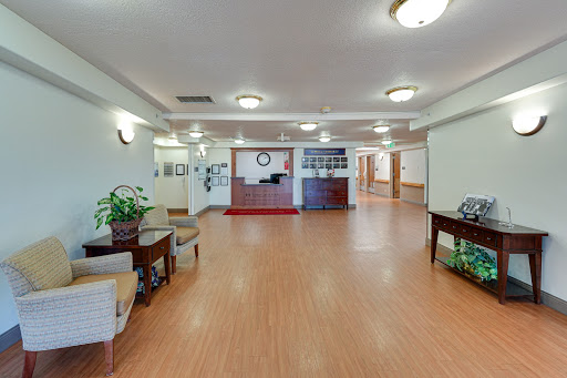 A spacious and welcoming lobby area featuring comfortable furniture and decorative plants.