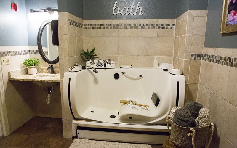 A luxurious bathroom features a spacious bathtub with modern fixtures and elegant decor.