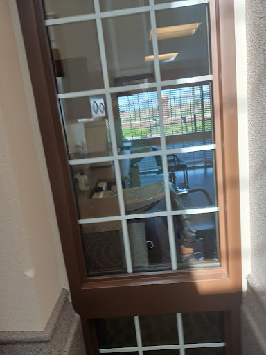 A view through a glass-paneled door into an office space.