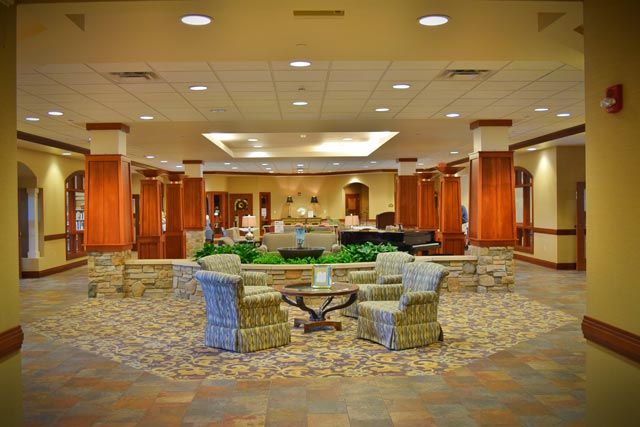 A spacious and elegantly decorated lobby featuring comfortable seating arrangements.