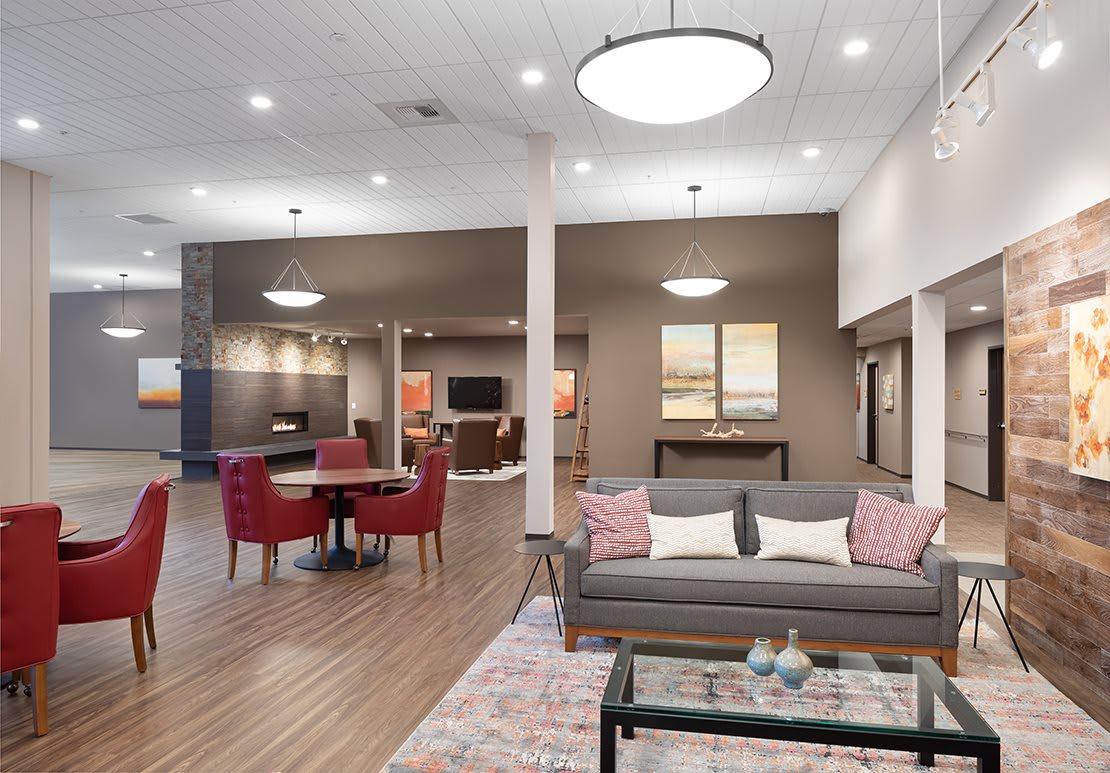 A modern open-concept living area with stylish furniture and warm lighting.