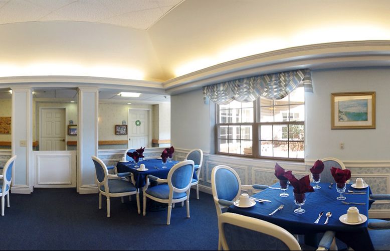 A stylish dining area with blue chairs and elegantly set tables.