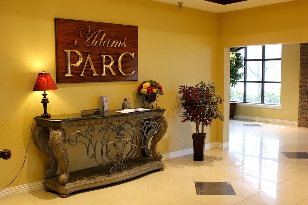Reception area with a decorative desk and indoor plants.