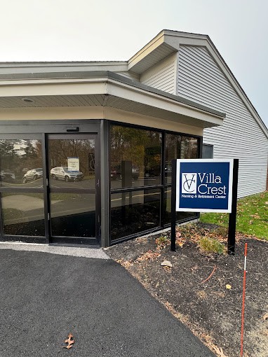 Entrance to a building with a sign that reads 'Villa Crest Nursing and Retirement Center'.