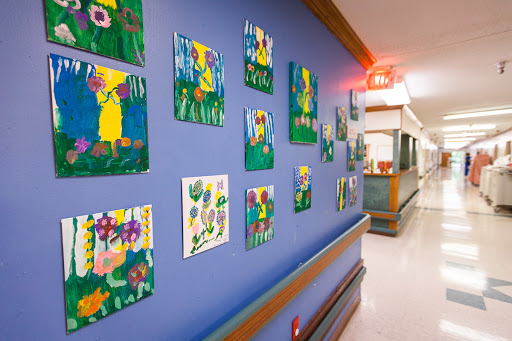 Colorful children's artwork brightening the hallway of a hospital.