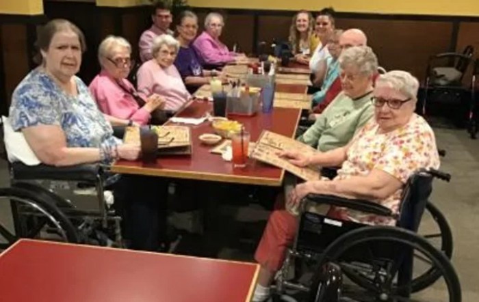 A group of seniors enjoying a meal together at a restaurant.