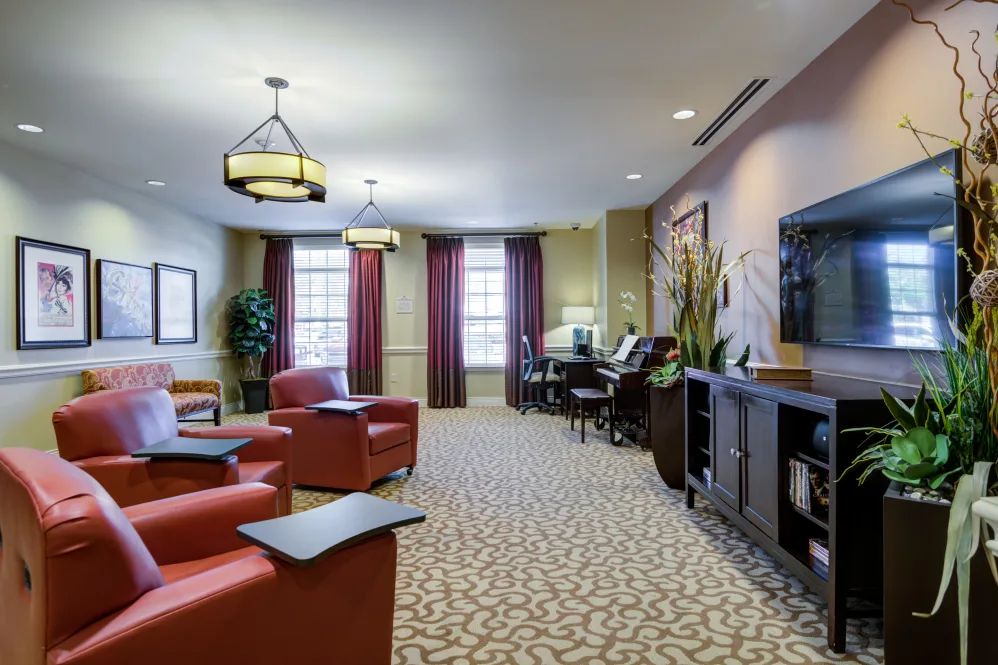 A well-furnished living room with comfortable seating, television, and elegant decor.