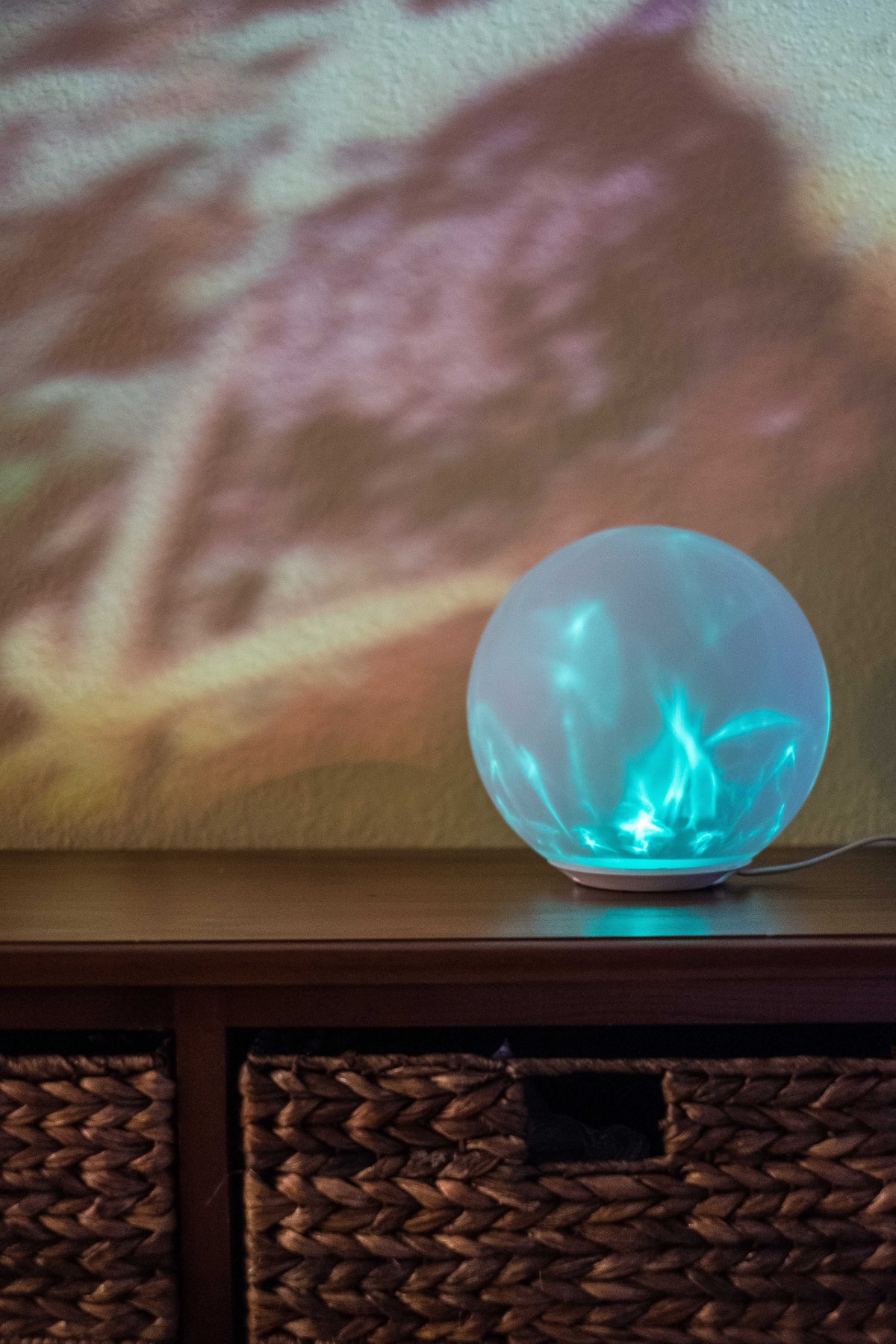 A colorful glowing sphere projecting light onto a wall, creating a vibrant decor element.