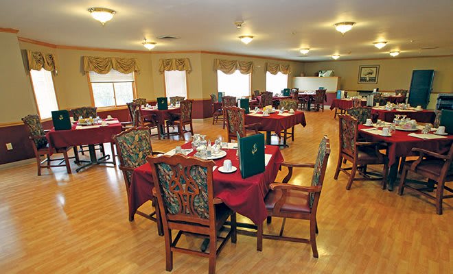 An elegant dining room with neatly arranged tables and chairs.