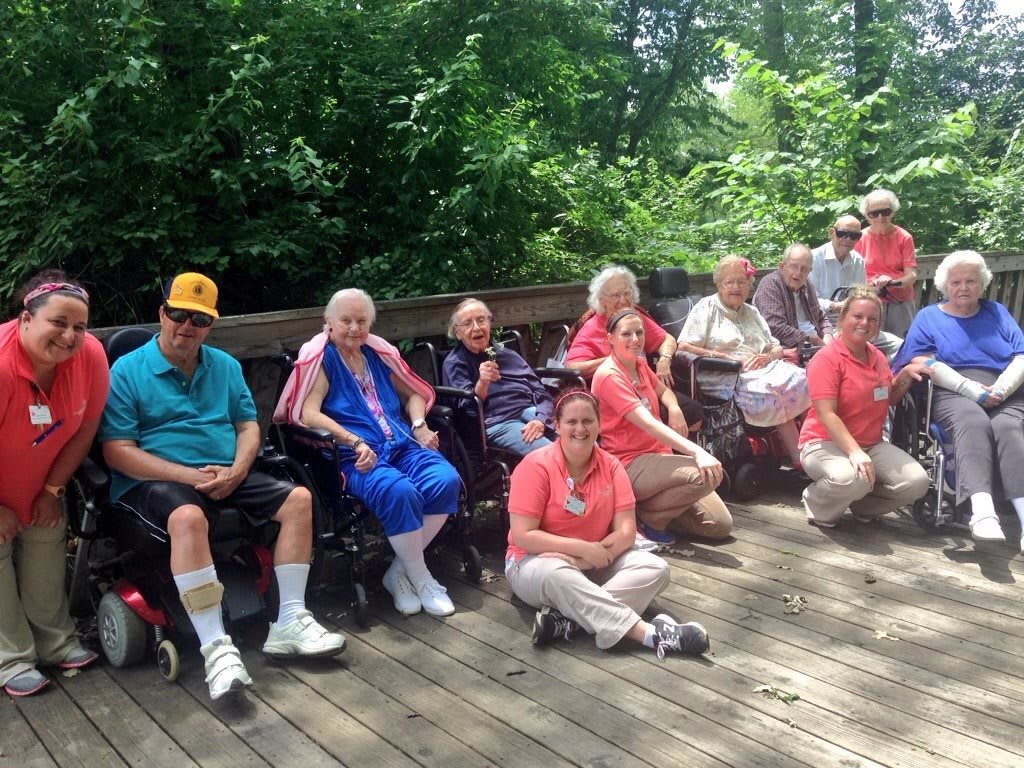 A group of seniors enjoying a sunny day outdoors in the park.