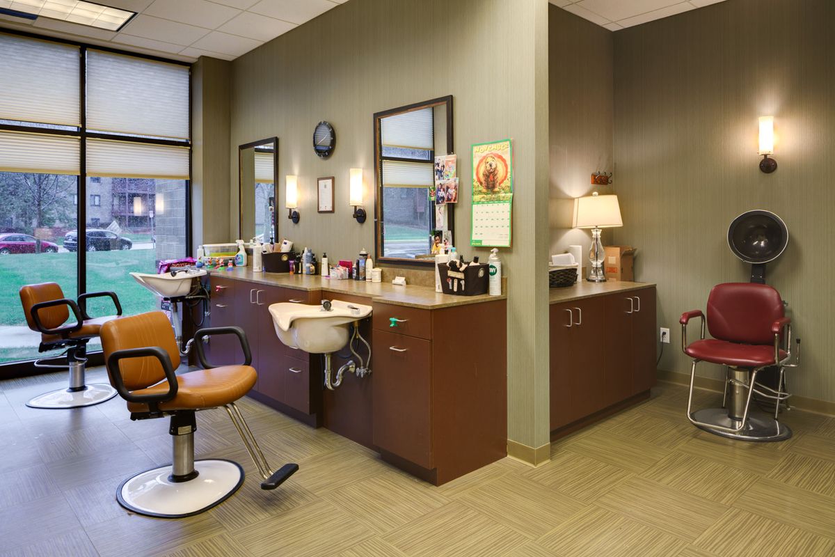 A well-organized hair salon interior with barber chairs and mirrors.