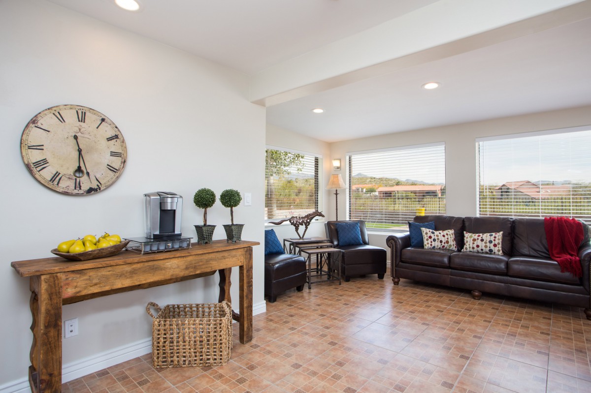 A cozy living room with stylish decor, featuring comfortable seating and ample natural light.