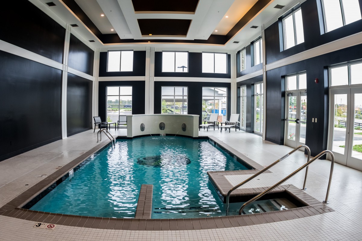 A luxurious indoor pool area with modern design and large windows.